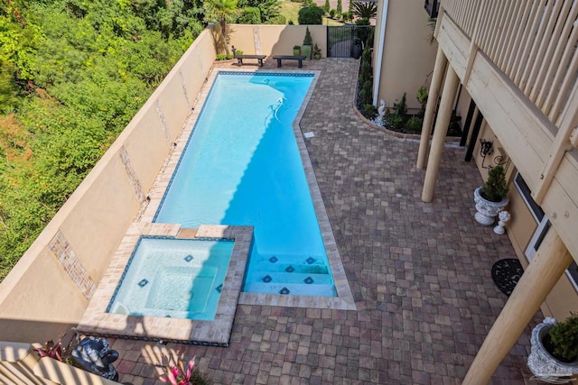 view of swimming pool with an in ground hot tub and a patio area