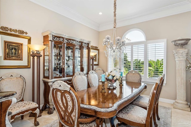 tiled dining space with crown molding, ornate columns, and a chandelier