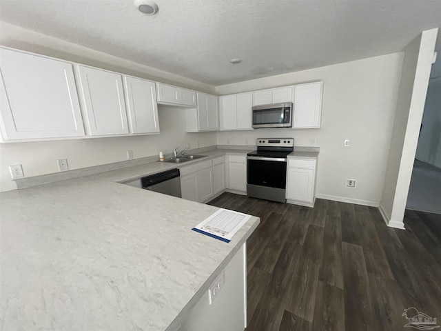 kitchen featuring white cabinets, dark hardwood / wood-style flooring, and appliances with stainless steel finishes