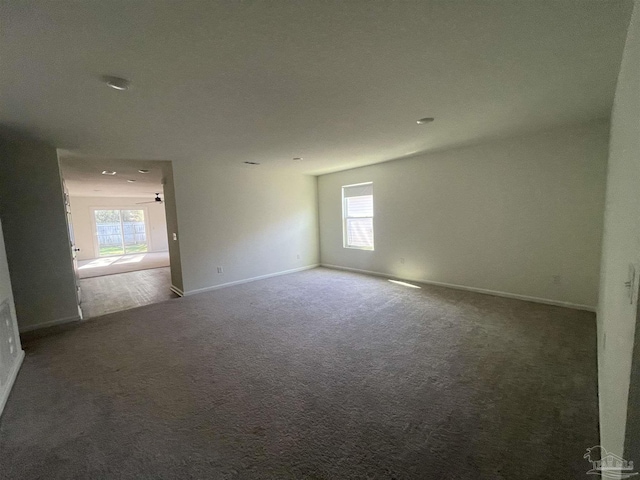 unfurnished room with carpet flooring and ceiling fan