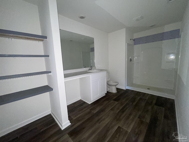 bathroom featuring hardwood / wood-style floors, toilet, a shower, and vanity