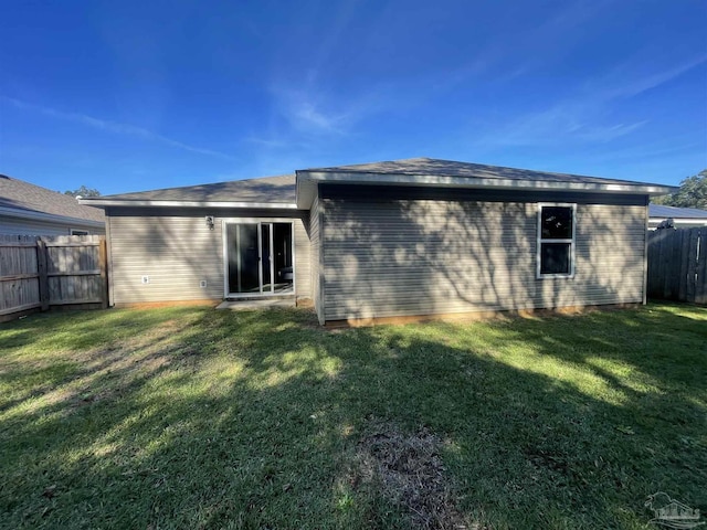 rear view of house with a lawn