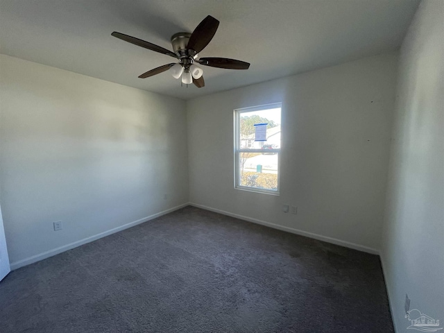 empty room featuring dark colored carpet and ceiling fan