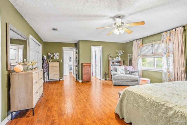 2803 Venetian Way, Gulf Breeze, FL 32563 - bedroom with light wood-type flooring, a textured ceiling, baseboards, and ensuite bathroom