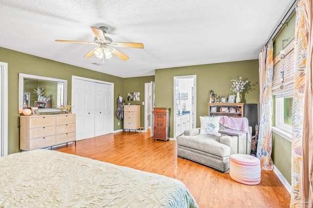 2803 Venetian Way, Gulf Breeze, FL 32563 - bedroom featuring wood finished floors, baseboards, ceiling fan, a textured ceiling, and ensuite bath