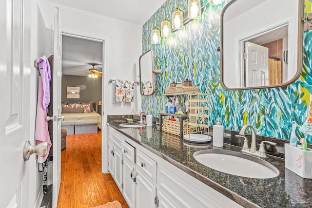 2803 Venetian Way, Gulf Breeze, FL 32563 - bathroom with connected bathroom, double vanity, wood finished floors, and ceiling fan