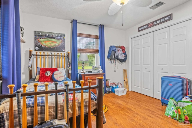 2803 Venetian Way, Gulf Breeze, FL 32563 - bedroom featuring light wood finished floors, a closet, and a textured ceiling
