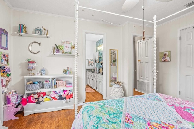 2803 Venetian Way, Gulf Breeze, FL 32563 - bedroom with wood finished floors, ornamental molding, ensuite bathroom, and a ceiling fan