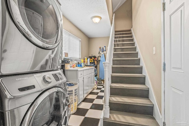 2803 Venetian Way, Gulf Breeze, FL 32563 - laundry area featuring estacked washer and dryer and tile patterned floors