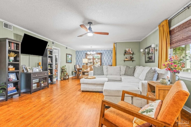 2803 Venetian Way, Gulf Breeze, FL 32563 - living room featuring ornamental molding, a textured ceiling, ceiling fan, light wood finished floors, and a chandelier