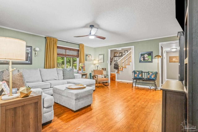 2803 Venetian Way, Gulf Breeze, FL 32563 - living room featuring ornamental molding, a ceiling fan, stairway, light wood-style floors, and a textured ceiling