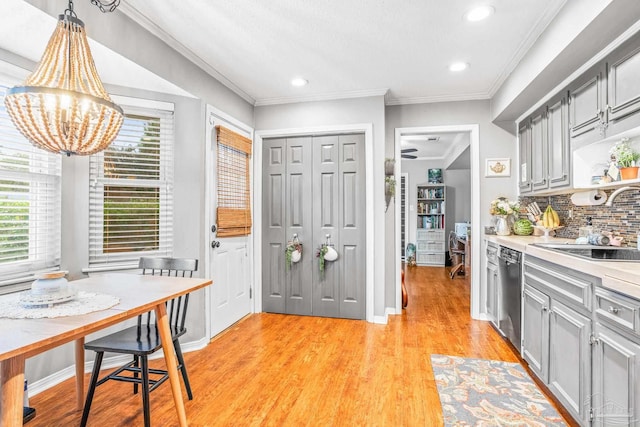 2803 Venetian Way, Gulf Breeze, FL 32563 - kitchen featuring dishwasher, gray cabinets, a sink, a chandelier, and ornamental molding
