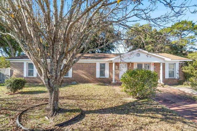 single story home featuring brick siding and a front lawn