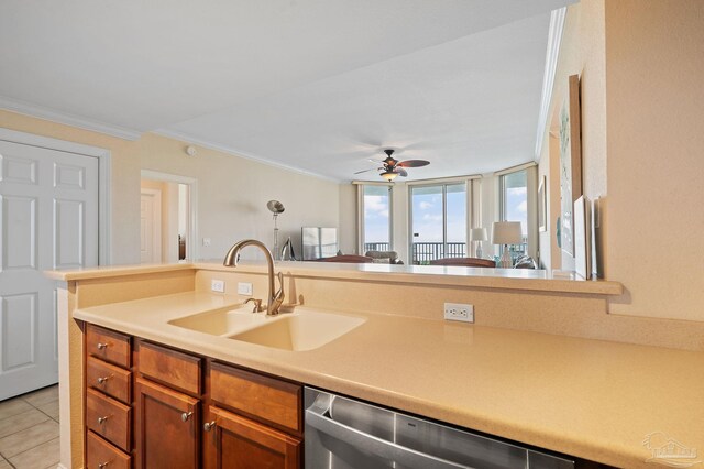 kitchen featuring ceiling fan, dishwasher, sink, crown molding, and light tile patterned flooring