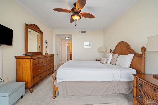 carpeted bedroom with ceiling fan and ornamental molding