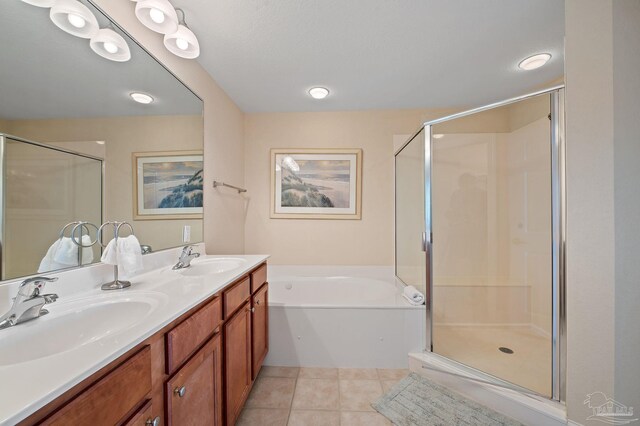 bathroom featuring independent shower and bath, dual bowl vanity, and tile patterned flooring