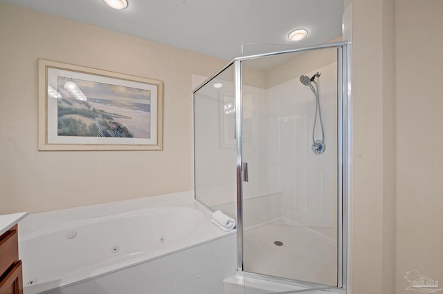 bathroom with shower with separate bathtub and vanity