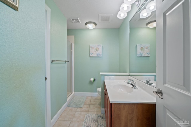 bathroom with tile patterned flooring, a shower with door, toilet, and vanity