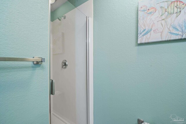 bathroom with a shower with shower door