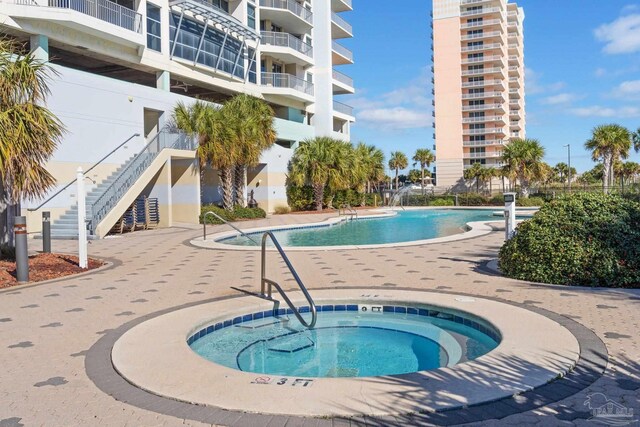 view of pool featuring a hot tub