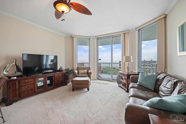 living room with ceiling fan, light carpet, and crown molding