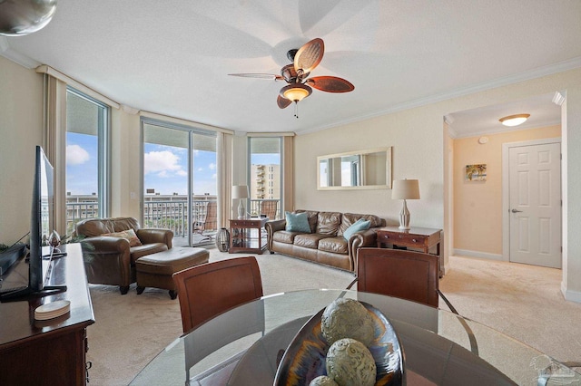 living room featuring expansive windows, a textured ceiling, light carpet, ceiling fan, and crown molding