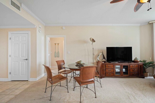 dining space with ceiling fan, ornamental molding, and light tile patterned floors