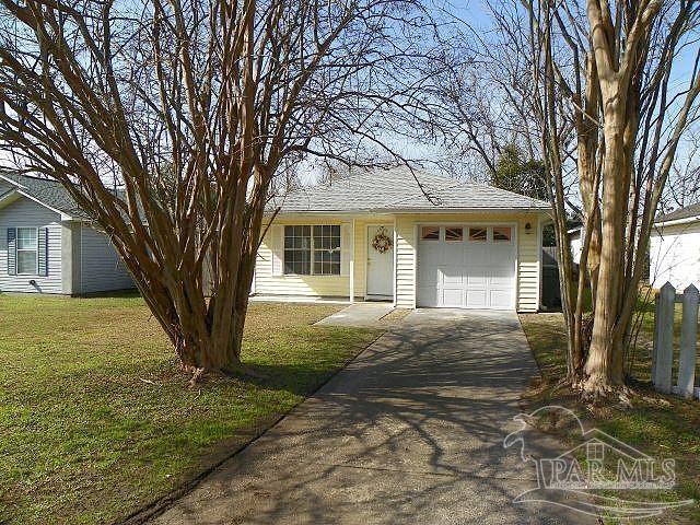 single story home with a garage and a front yard