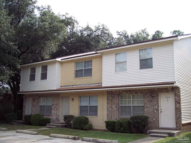 view of front of home featuring entry steps and brick siding