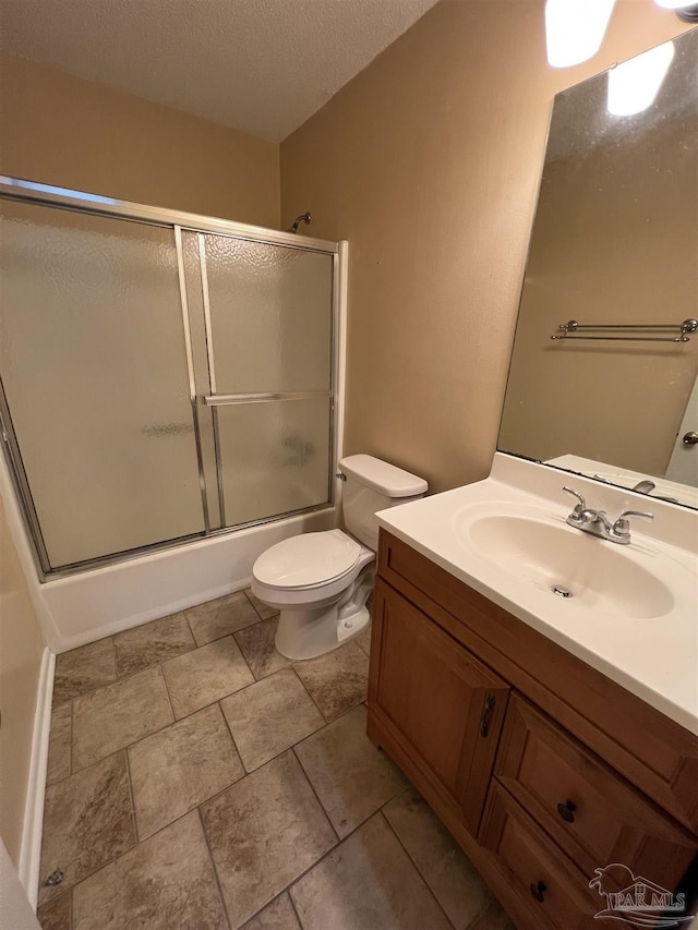 full bathroom featuring toilet, enclosed tub / shower combo, a textured ceiling, and vanity