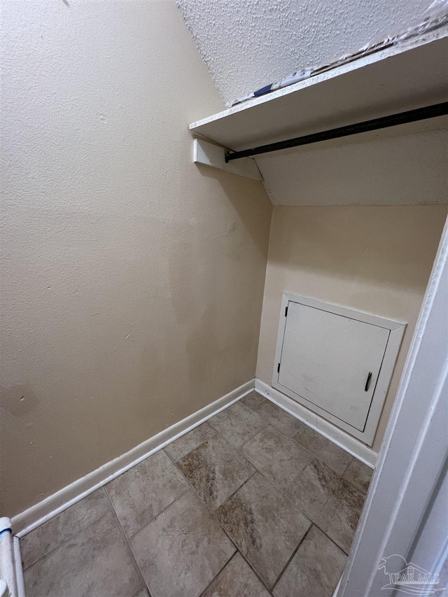 washroom with baseboards