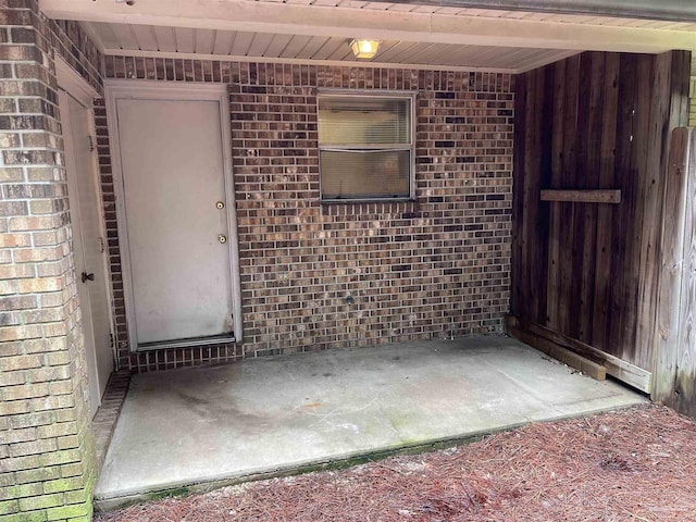 property entrance featuring brick siding