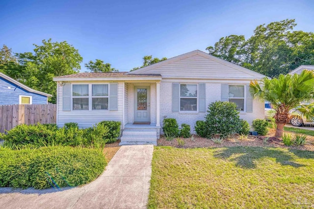 bungalow-style house featuring a front yard