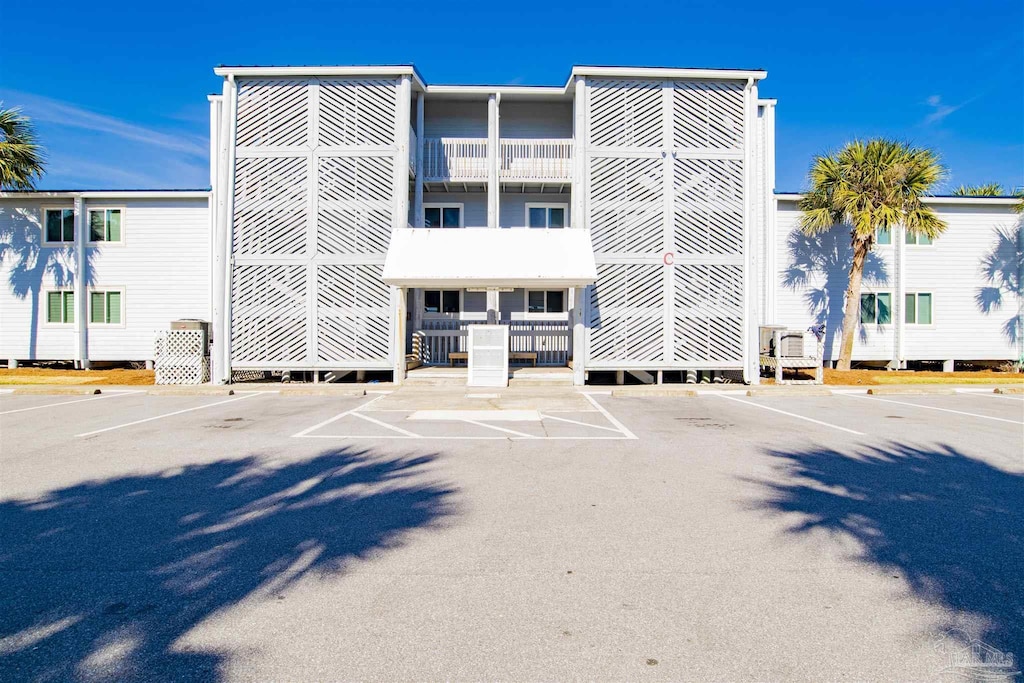 view of building exterior featuring uncovered parking