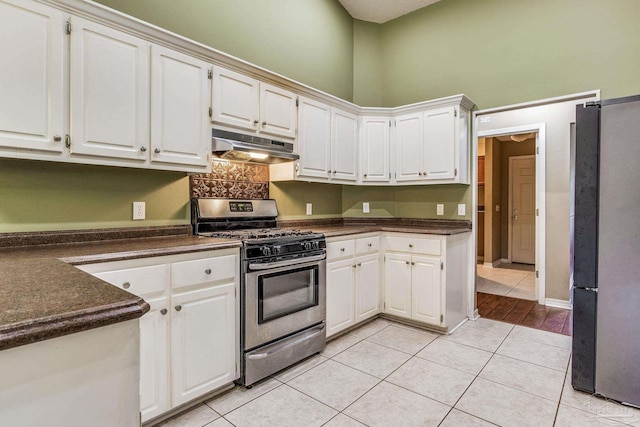 kitchen featuring white cabinets, light tile patterned floors, and appliances with stainless steel finishes