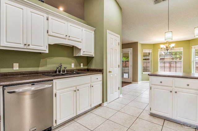 kitchen with a textured ceiling, sink, dishwasher, white cabinetry, and hanging light fixtures