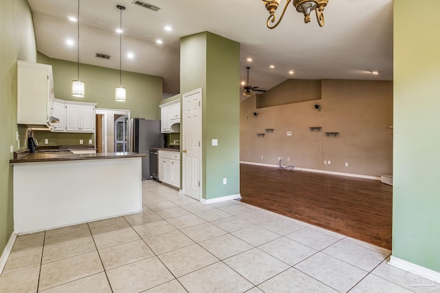 kitchen featuring ceiling fan, stainless steel appliances, pendant lighting, white cabinets, and light wood-type flooring