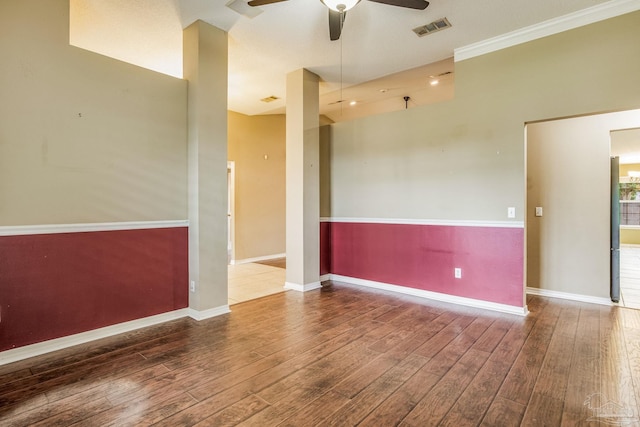 empty room with ceiling fan, wood-type flooring, and crown molding