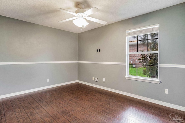 empty room with dark hardwood / wood-style floors, ceiling fan, and a textured ceiling