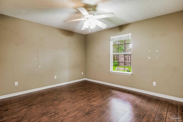 empty room featuring ceiling fan, dark hardwood / wood-style flooring, and a textured ceiling