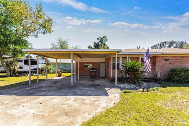 view of front of house with a carport and a front lawn