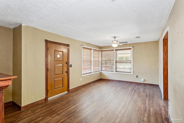 interior space featuring dark hardwood / wood-style floors, a textured ceiling, and ceiling fan