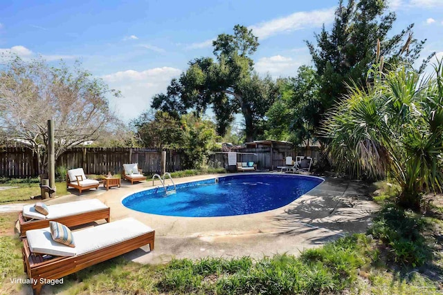 view of swimming pool featuring a patio area