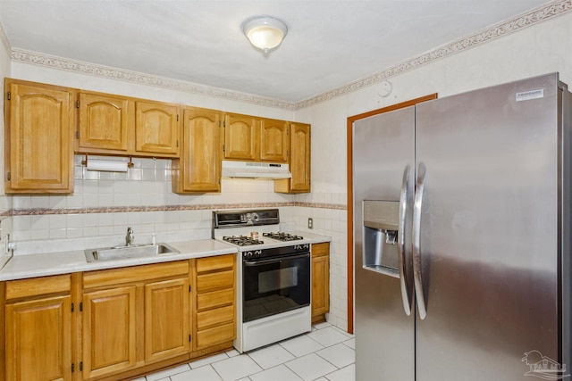 kitchen featuring light tile patterned floors, white gas range oven, sink, and stainless steel refrigerator with ice dispenser