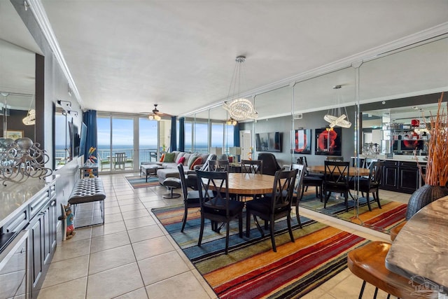 tiled dining area featuring crown molding, floor to ceiling windows, and ceiling fan