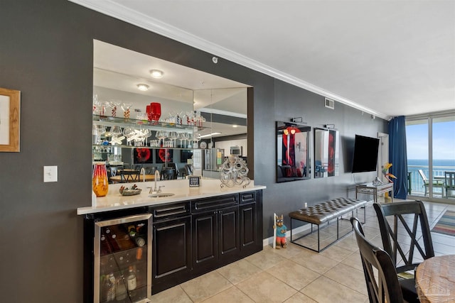 bar featuring light tile patterned floors, wet bar, a sink, wine cooler, and crown molding