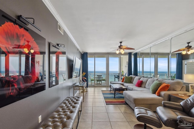 living room featuring visible vents, crown molding, ceiling fan, expansive windows, and tile patterned floors