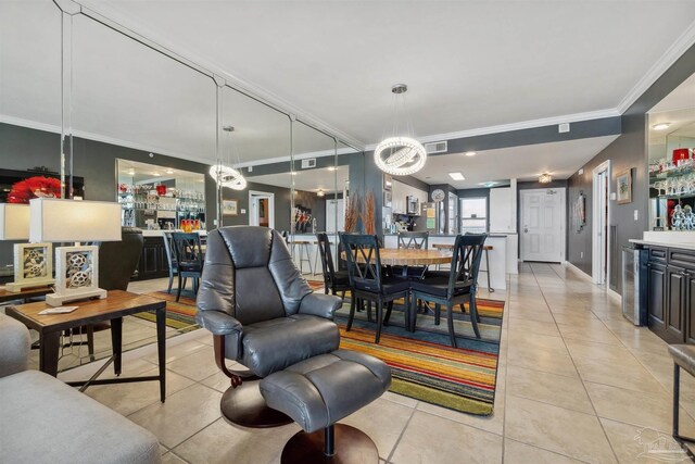 dining room featuring visible vents, a dry bar, crown molding, light tile patterned floors, and a chandelier