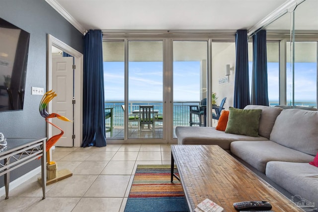 living area with a wealth of natural light, a water view, light tile patterned flooring, and crown molding