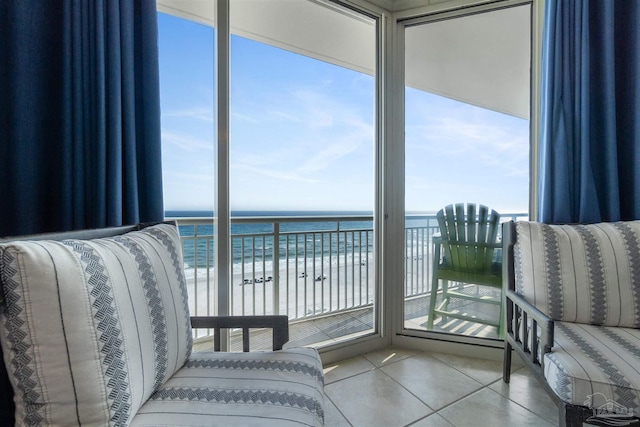 interior space featuring a beach view, plenty of natural light, and a water view